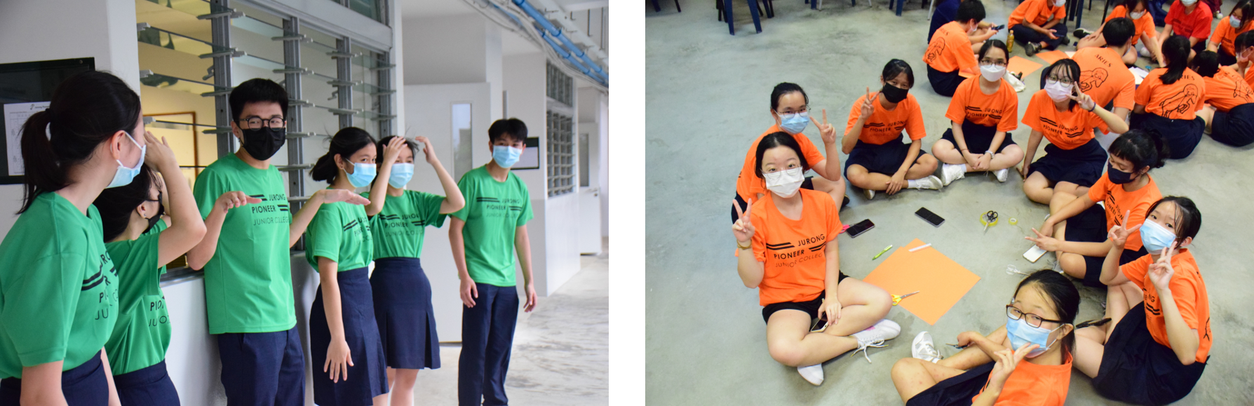 Students in green and orange Jurong Pioneer Junior College shirts wear masks while interacting indoors.